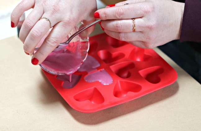 DIY valentine soap pour coloured soap into heart mold